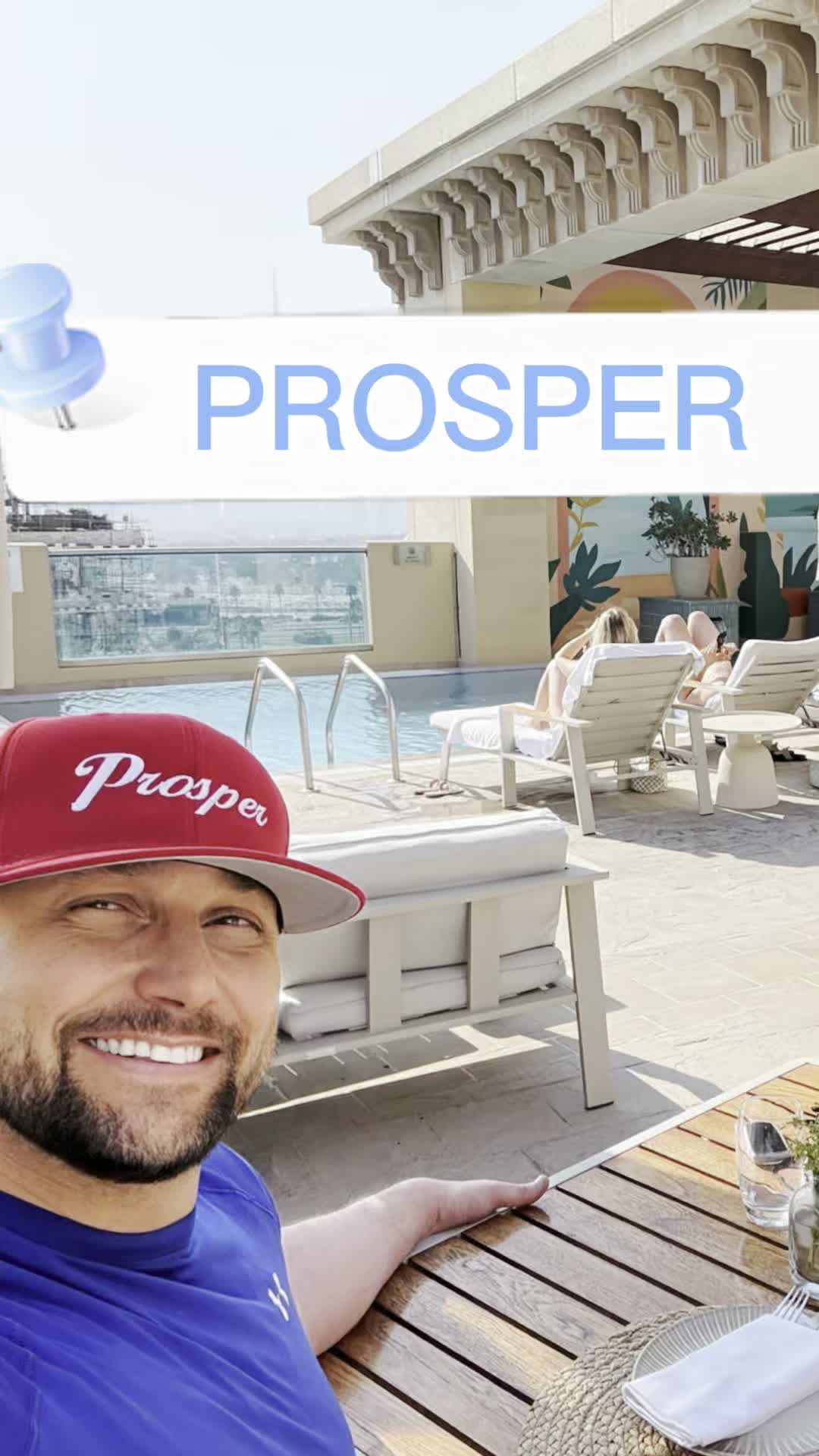 Craig Stratton wearing a Prosper hat beside a rooftop pool deck
